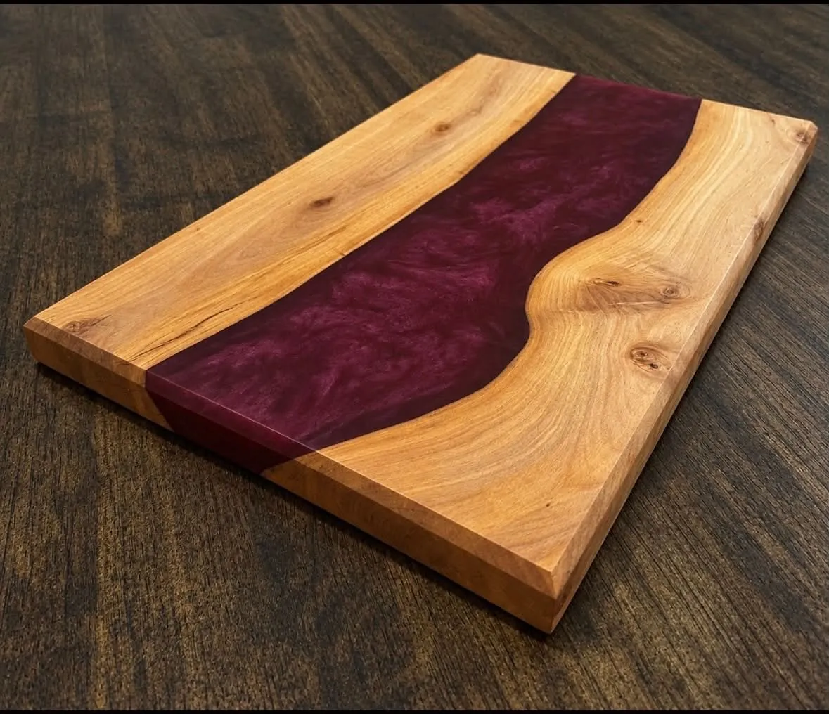 Full wooden board with a burgundy epoxy river