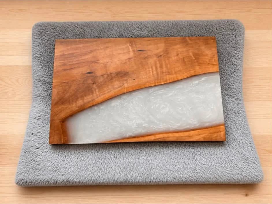Warm wood board with a wide, pale pearlescent epoxy section