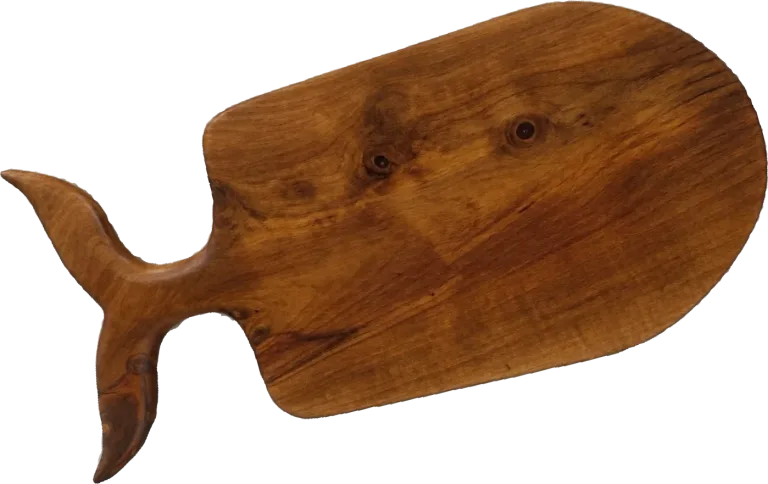 Handmade wooden serving board with a carved whale-tail handle