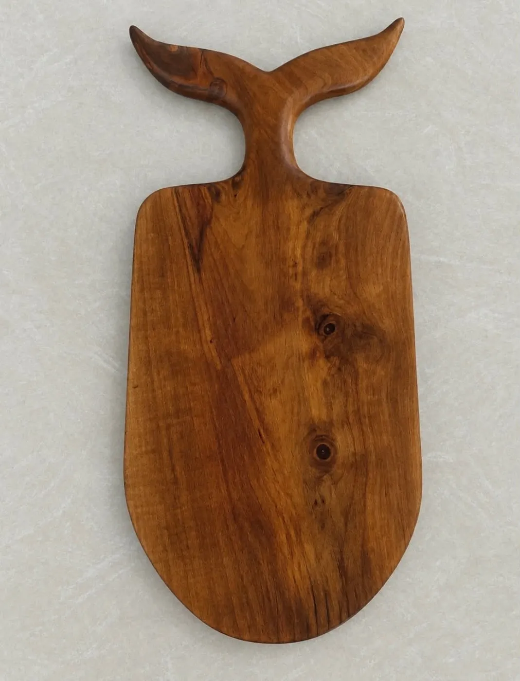 Full serving board with a sculpted whale-tail handle